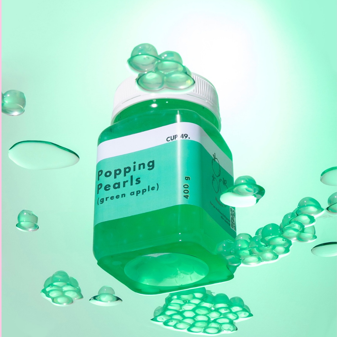 Green container labeled 'Popping Pearls (green apple)' with green pearls for bubble tea, milk tea, fruit tea, boba 