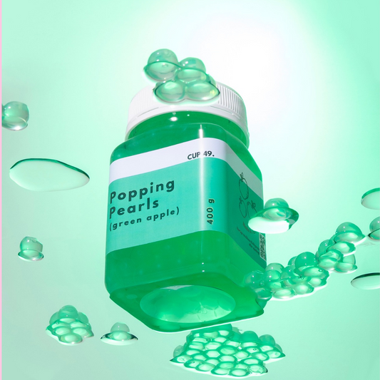 Green container labeled 'Popping Pearls (green apple)' with green pearls for bubble tea, milk tea, fruit tea, boba 